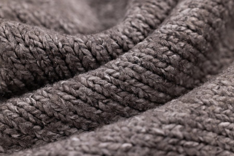 A close-up of a grey knitted sweater.