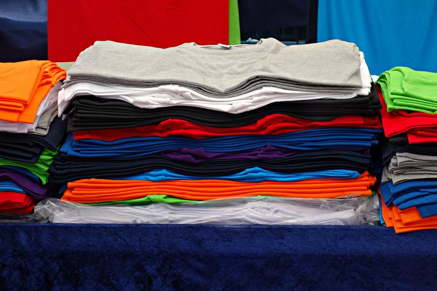 Folded shirts stacked in a pile.