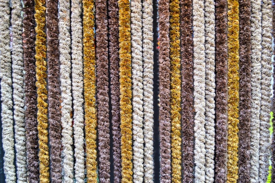 A close-up of a striped woven trouser fabric.