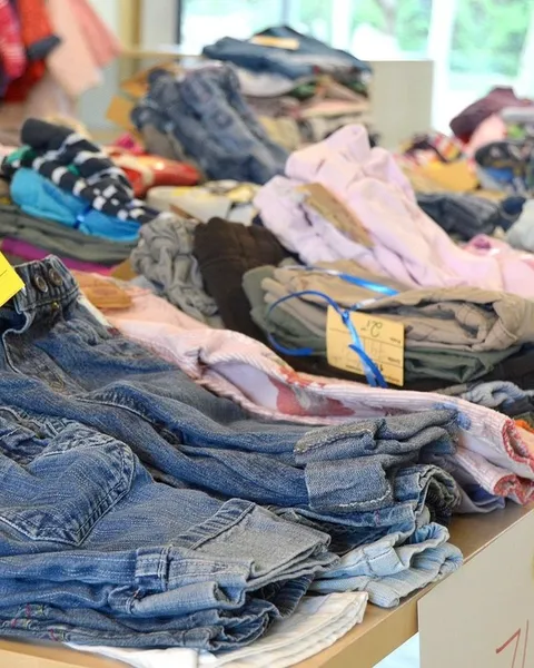 A rack of second-hand clothes at a market.