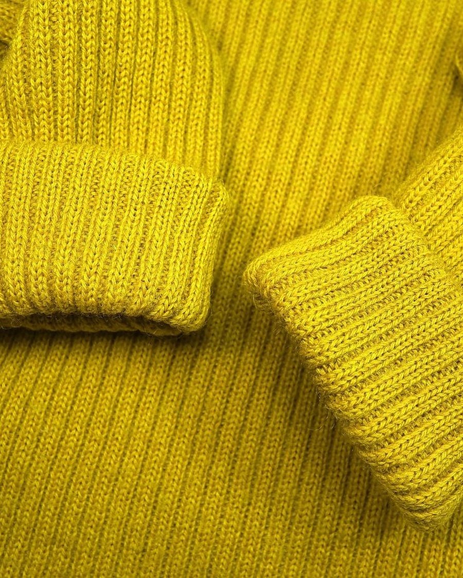A folded yellow rib-knit sleeve.
