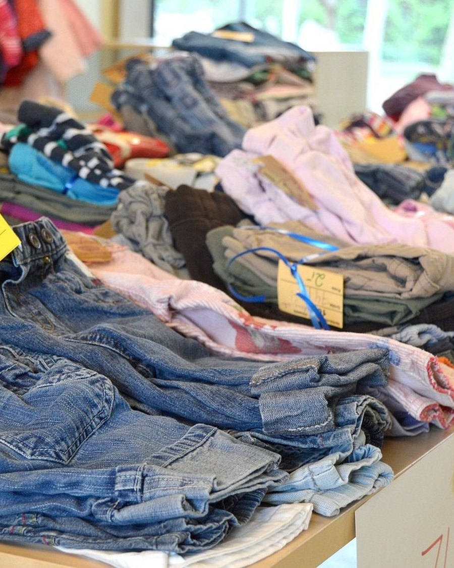 A rack of second-hand clothes at a market.